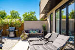 Enjoy outdoor living at its finest with this spacious patio, featuring a premium gas grill perfect for summer cookouts.