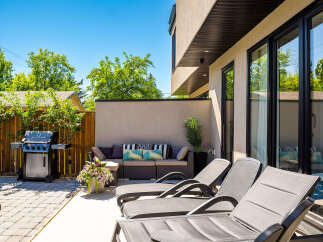 Enjoy outdoor living at its finest with this spacious patio, featuring a premium gas grill perfect for summer cookouts.