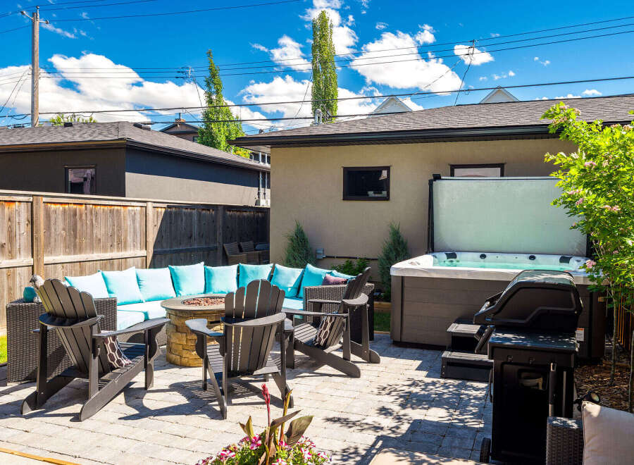 Enjoy ultimate relaxation and entertainment in this stunning backyard oasis, complete with a luxurious hot tub and a cozy fire pit seating area.