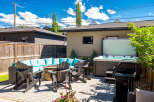 Enjoy ultimate relaxation and entertainment in this stunning backyard oasis, complete with a luxurious hot tub and a cozy fire pit seating area.