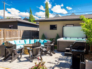 Enjoy ultimate relaxation and entertainment in this stunning backyard oasis, complete with a luxurious hot tub and a cozy fire pit seating area.