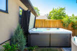 Enjoy ultimate relaxation in this backyard oasis, featuring a spacious hot tub perfect for unwinding.