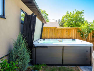 Enjoy ultimate relaxation in this backyard oasis, featuring a spacious hot tub perfect for unwinding.
