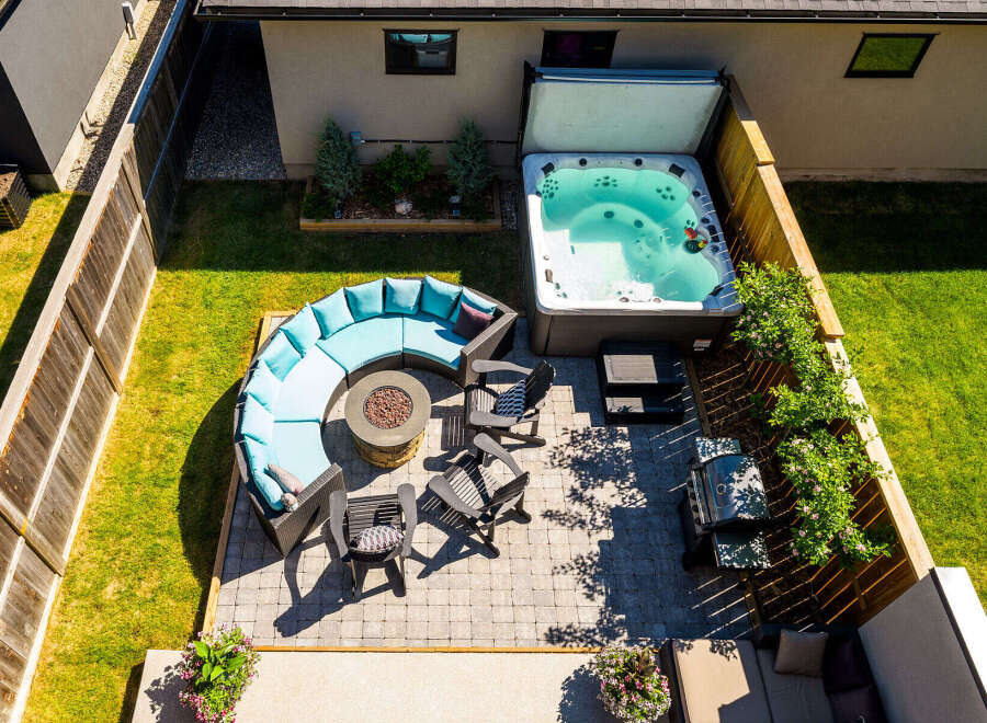 Experience ultimate relaxation in this stunning backyard oasis, featuring a luxurious hot tub perfect for unwinding.