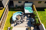 Experience ultimate relaxation in this stunning backyard oasis, featuring a luxurious hot tub perfect for unwinding.