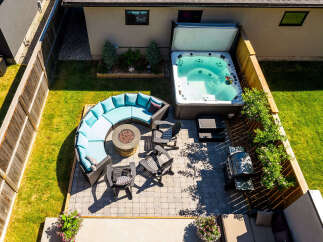Experience ultimate relaxation in this stunning backyard oasis, featuring a luxurious hot tub perfect for unwinding.