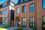 Discover modern urban living in this stunning townhouse featuring a classic red brick facade and sleek, contemporary design elements.