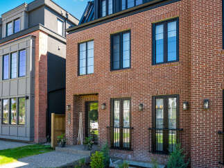 Discover modern urban living in this stunning townhouse featuring a classic red brick facade and sleek, contemporary design elements.