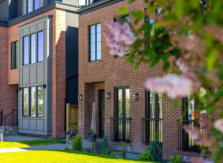 Discover modern urban living in this stunning townhouse featuring a striking brick facade and contemporary architectural details.