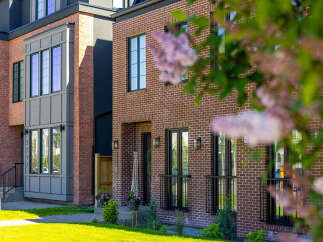 Discover modern urban living in this stunning townhouse featuring a striking brick facade and contemporary architectural details.
