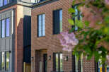 Discover modern urban living in this stunning townhouse featuring a striking brick facade and sleek, contemporary design elements.