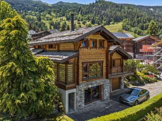 Experience luxury mountain living in this stunning wooden chalet, nestled amidst breathtaking alpine scenery.