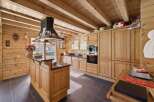 Experience rustic charm in this beautifully appointed log cabin kitchen, featuring warm wooden cabinetry and exposed beams.