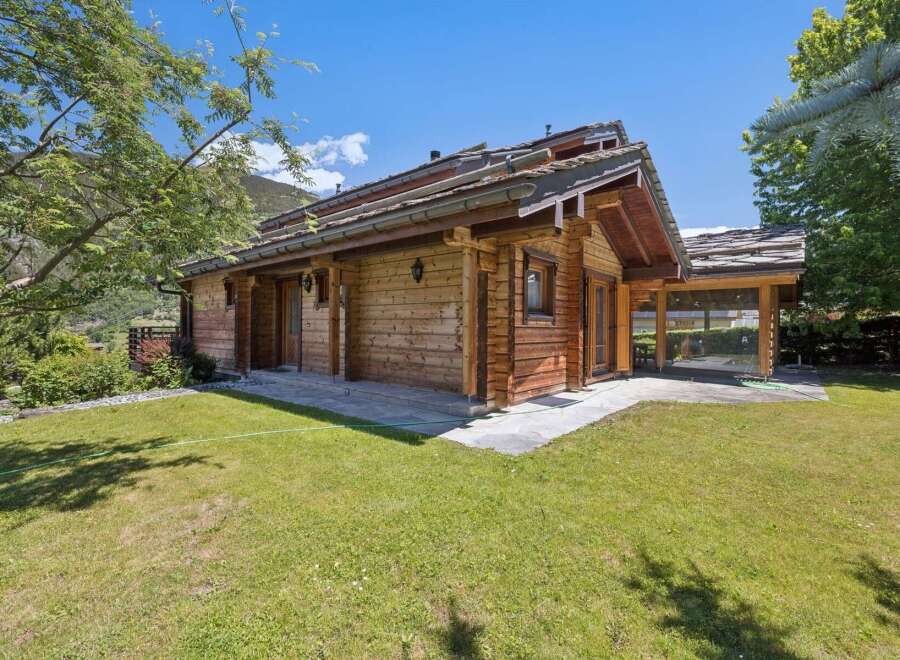 Experience serene mountain living in this charming wooden chalet, nestled amidst lush greenery and offering breathtaking views.