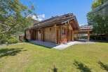 Experience serene mountain living in this charming wooden chalet, nestled amidst lush greenery and offering breathtaking views.