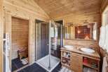 Experience rustic charm in this beautifully appointed bathroom featuring a spacious walk-in shower with sleek tilework.