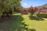 Discover this charming wooden cabin nestled in a lush green garden, perfect for a serene getaway.