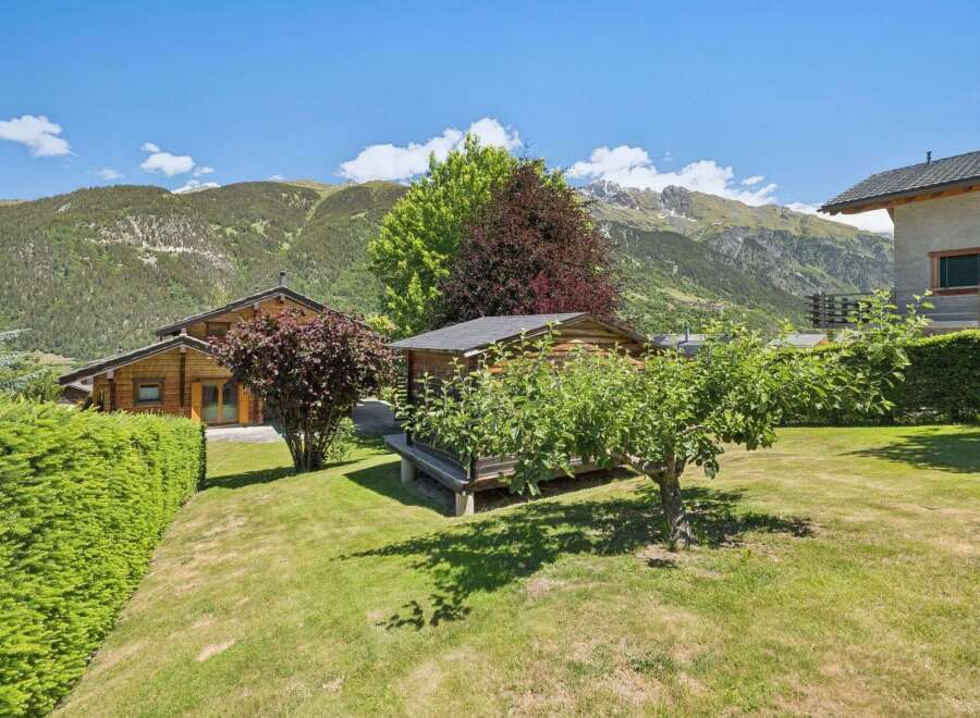 Nestled in a picturesque mountain setting, this charming property features a cozy wooden cabin and a well-maintained garden.