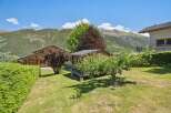 Nestled in a picturesque mountain setting, this charming property features a cozy wooden cabin and a well-maintained garden.