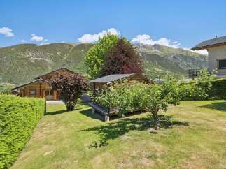 Nestled in a picturesque mountain setting, this charming property features a cozy wooden cabin and a well-maintained garden.