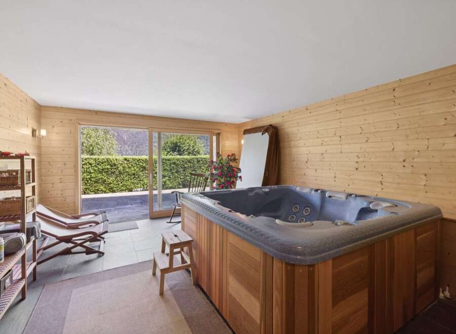 Indulge in relaxation in this luxurious indoor hot tub room, featuring a spacious jacuzzi perfect for unwinding.