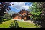 Experience serene mountain living in this charming log cabin, nestled amidst lush greenery and breathtaking alpine views.