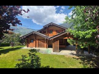 Experience serene mountain living in this charming log cabin, nestled amidst lush greenery and breathtaking alpine views.