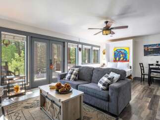 Experience cozy living in this charming studio apartment, featuring a comfortable sofa and a plush bed perfect for relaxation.