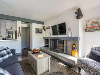 Cozy living room featuring a modern fireplace with a TV mounted above, perfect for relaxing evenings.