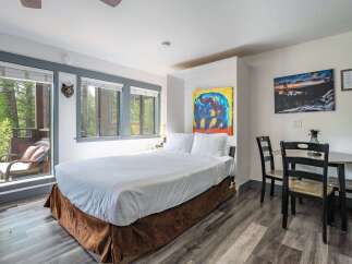 Experience cozy mountain living in this charming studio featuring a comfortable queen-size bed and a convenient dining area.