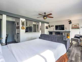 Experience the perfect blend of comfort and style in this studio apartment, featuring a cozy sleeping area, a well-equipped kitchenette, and a inviting living space with a fireplace.
