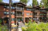 Discover this charming multi-level condo nestled amongst tall pine trees, offering a rustic mountain retreat.