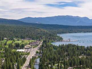 Experience the ultimate lakeside living with this stunning property offering breathtaking views of the serene lake and majestic mountains.