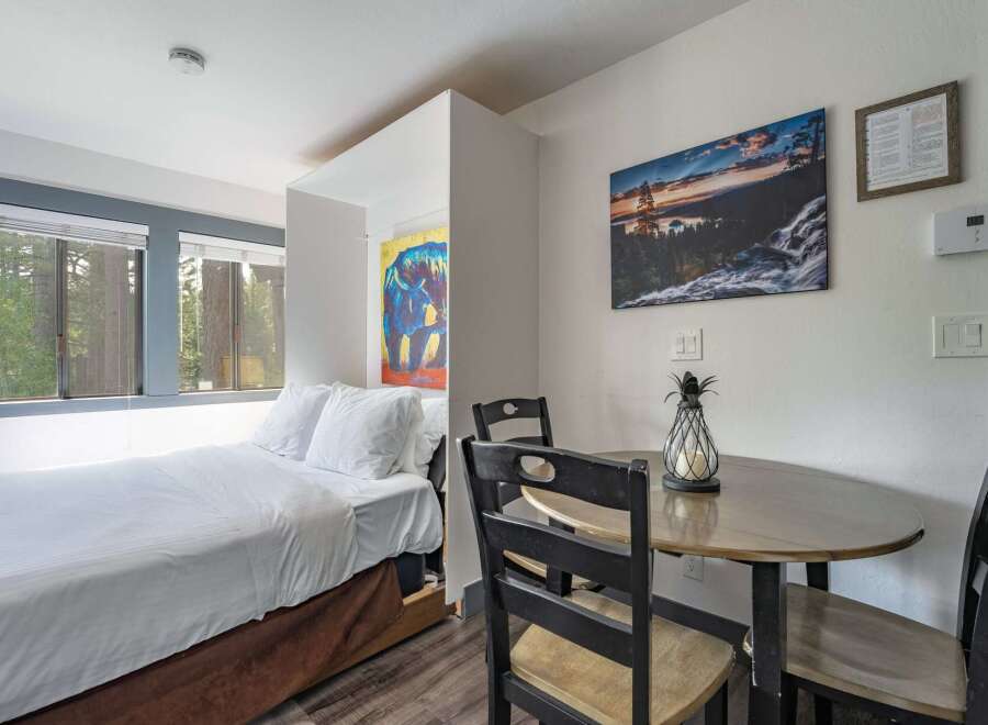 Experience comfort and convenience in this charming studio featuring a cozy bed and a dedicated dining area perfect for meals or work.