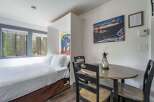 Experience comfort and convenience in this charming studio featuring a cozy bed and a dedicated dining area perfect for meals or work.