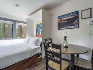 Experience comfort and convenience in this charming studio featuring a cozy bed and a dedicated dining area perfect for meals or work.
