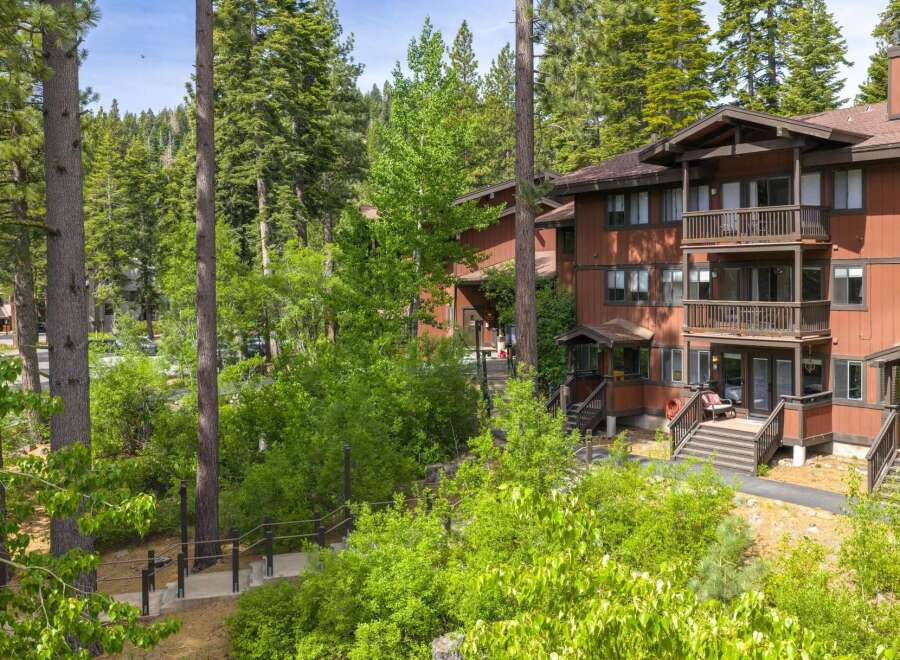 Nestled amidst towering pine trees, this charming multi-level residence offers a serene mountain getaway.