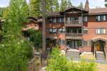 Nestled amidst towering trees, this charming multi-level residence offers a serene mountain retreat.