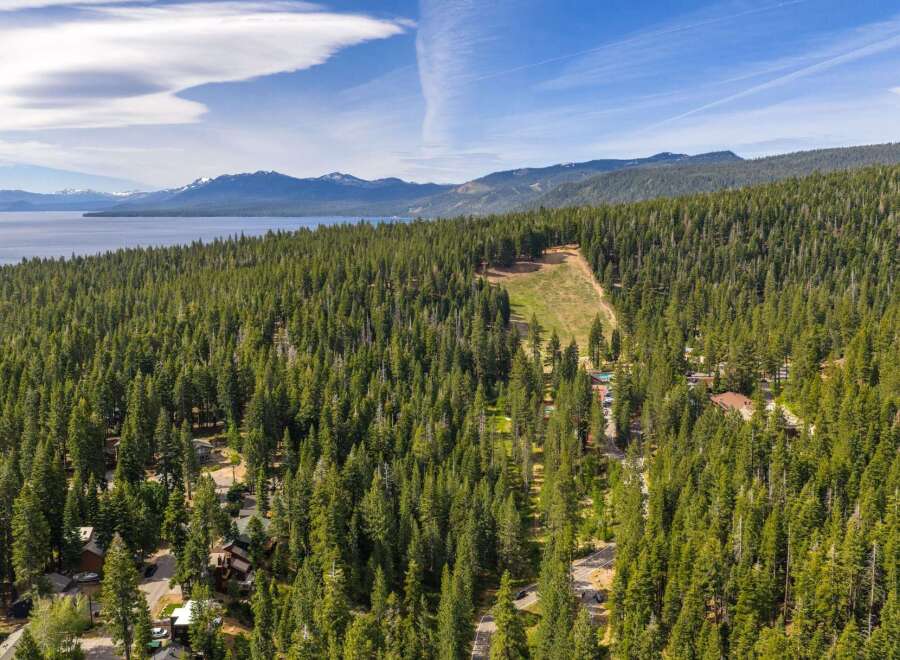 Discover your dream mountain retreat nestled amidst a dense forest with stunning lake and mountain views.