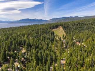 Discover your dream mountain retreat nestled amidst a dense forest with stunning lake and mountain views.