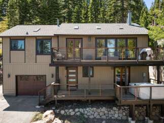 Experience luxury mountain living in this stunning multi-level home, featuring expansive decks perfect for entertaining or enjoying the serene forest views.