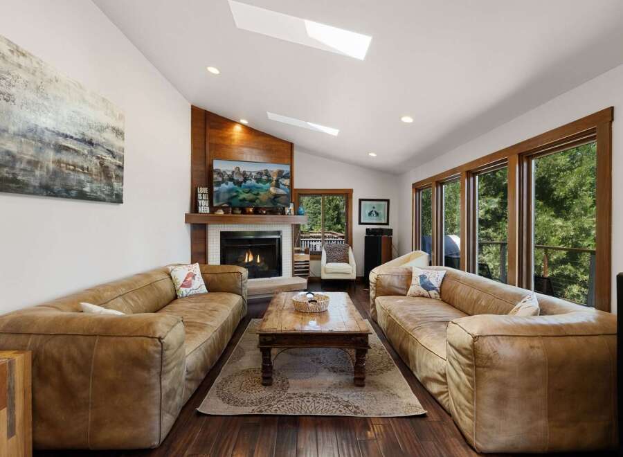 Experience ultimate relaxation in this spacious living room, featuring plush leather sofas perfect for gathering with loved ones.