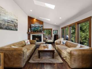 Experience ultimate relaxation in this spacious living room, featuring plush leather sofas perfect for gathering with loved ones.