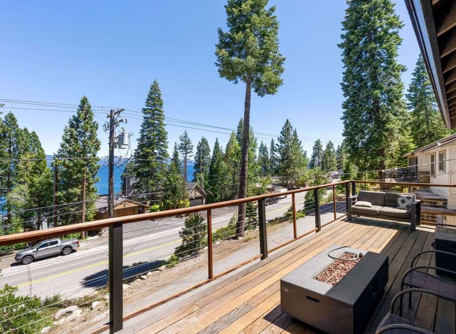 Enjoy breathtaking lake views from this stunning property's expansive deck, perfect for entertaining or relaxing.