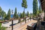 Enjoy breathtaking lake views from this stunning property's expansive deck, perfect for entertaining or relaxing.
