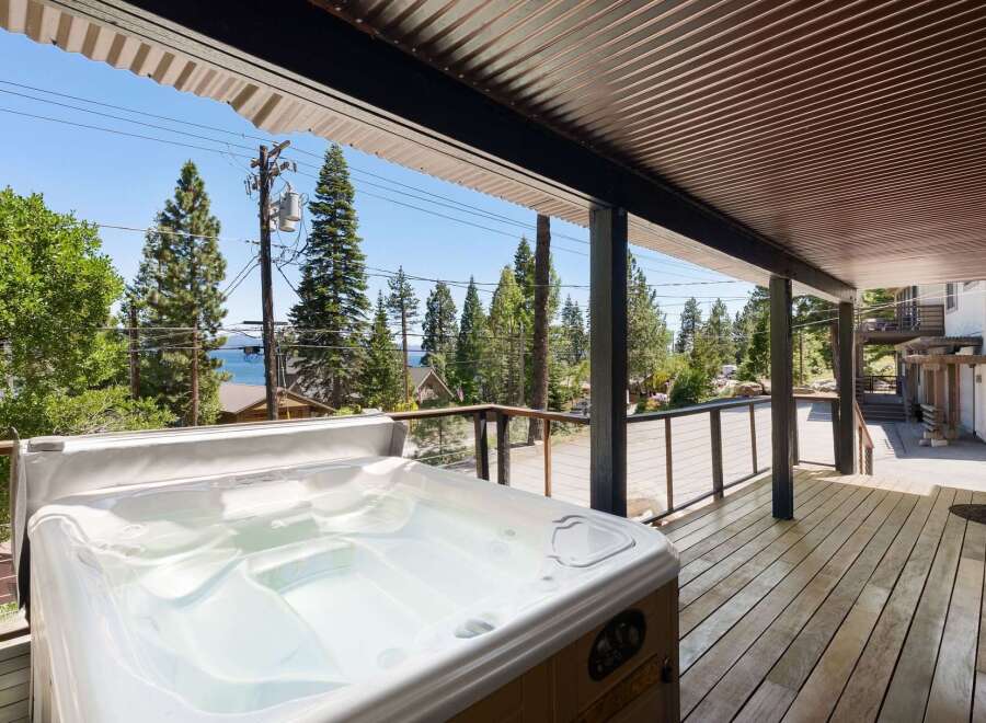 Enjoy ultimate relaxation in this stunning property featuring a luxurious hot tub on a spacious wooden deck.
