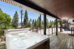Enjoy ultimate relaxation in this stunning property featuring a luxurious hot tub on a spacious wooden deck.