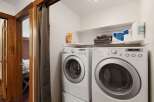 This laundry room features a stacked LG washer and dryer set, ensuring efficient and convenient laundry care.