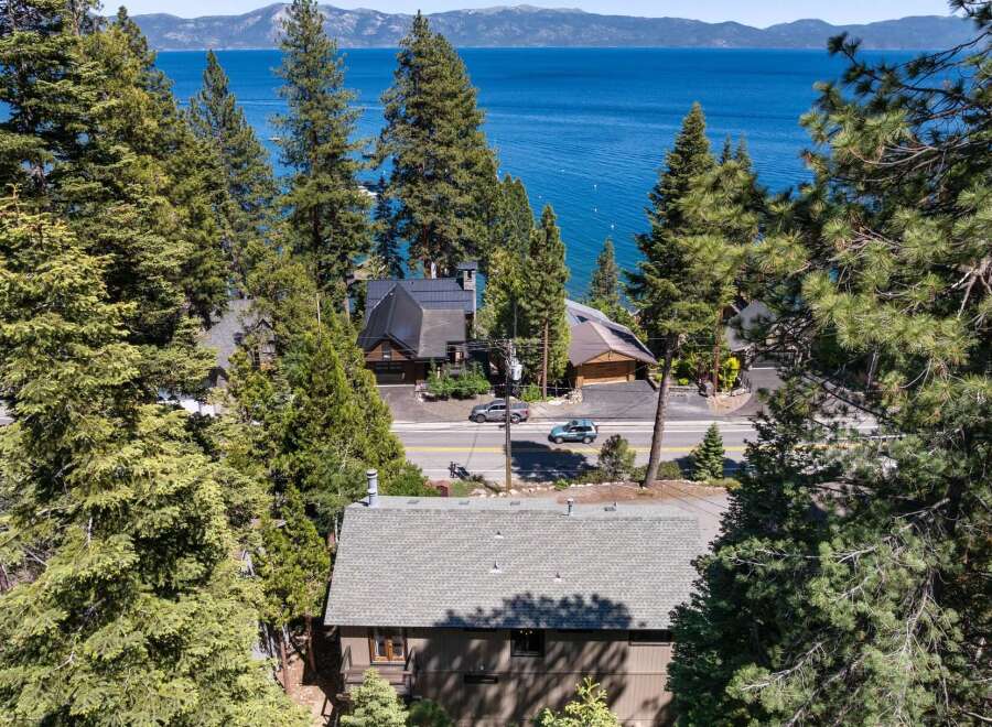 Experience breathtaking lake views from this stunning property nestled among tall pine trees.