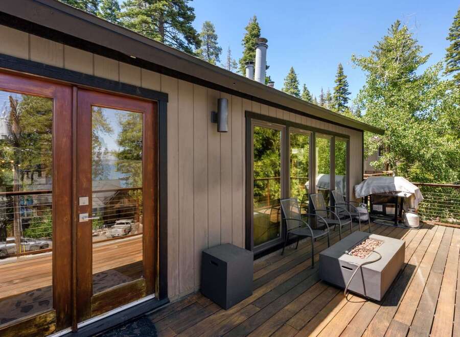 Enjoy outdoor living on this spacious wooden deck, perfect for entertaining or relaxing amidst nature.